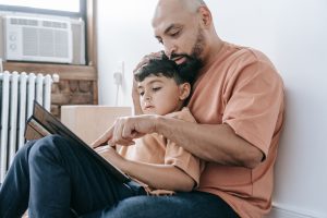 Parent with son looking at a laptop discussing online safety